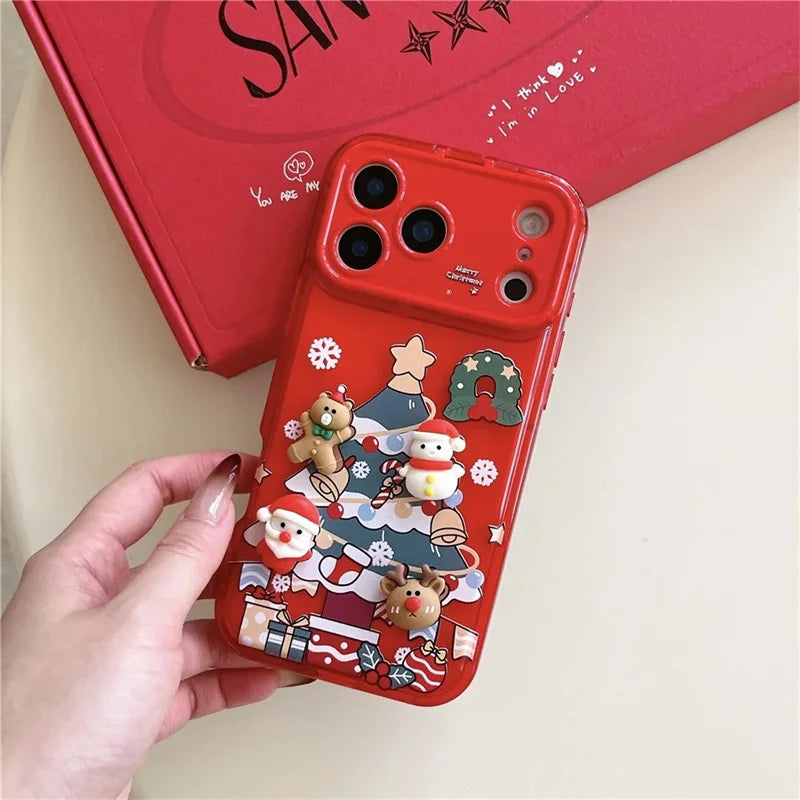 Rote iPhone-Hülle mit 3D-Weihnachtsbaum, Weihnachtsmann, Bär und Rentier, in Hand gehalten vor roter Box
